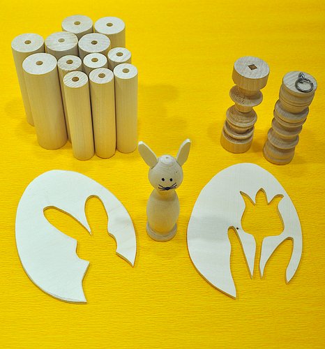 Wooden models in Easter themes on a yellow table cloth